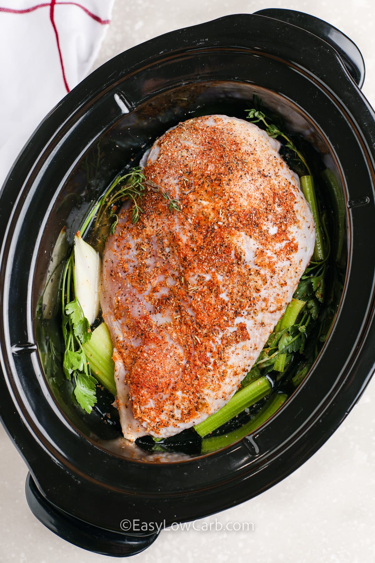 A turkey breast prepped in a crockpot