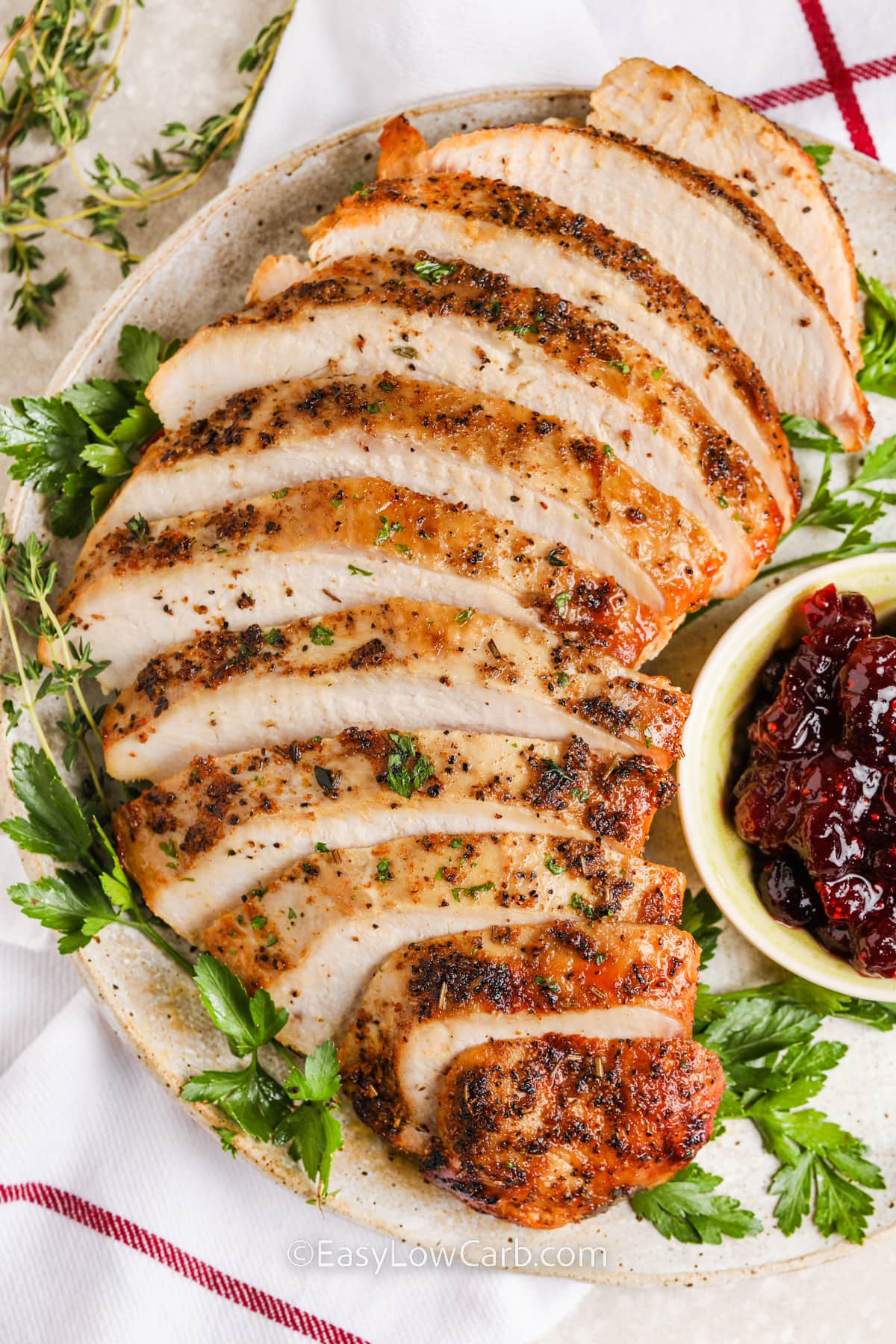 A serving plate with crockpot turkey breast on it.