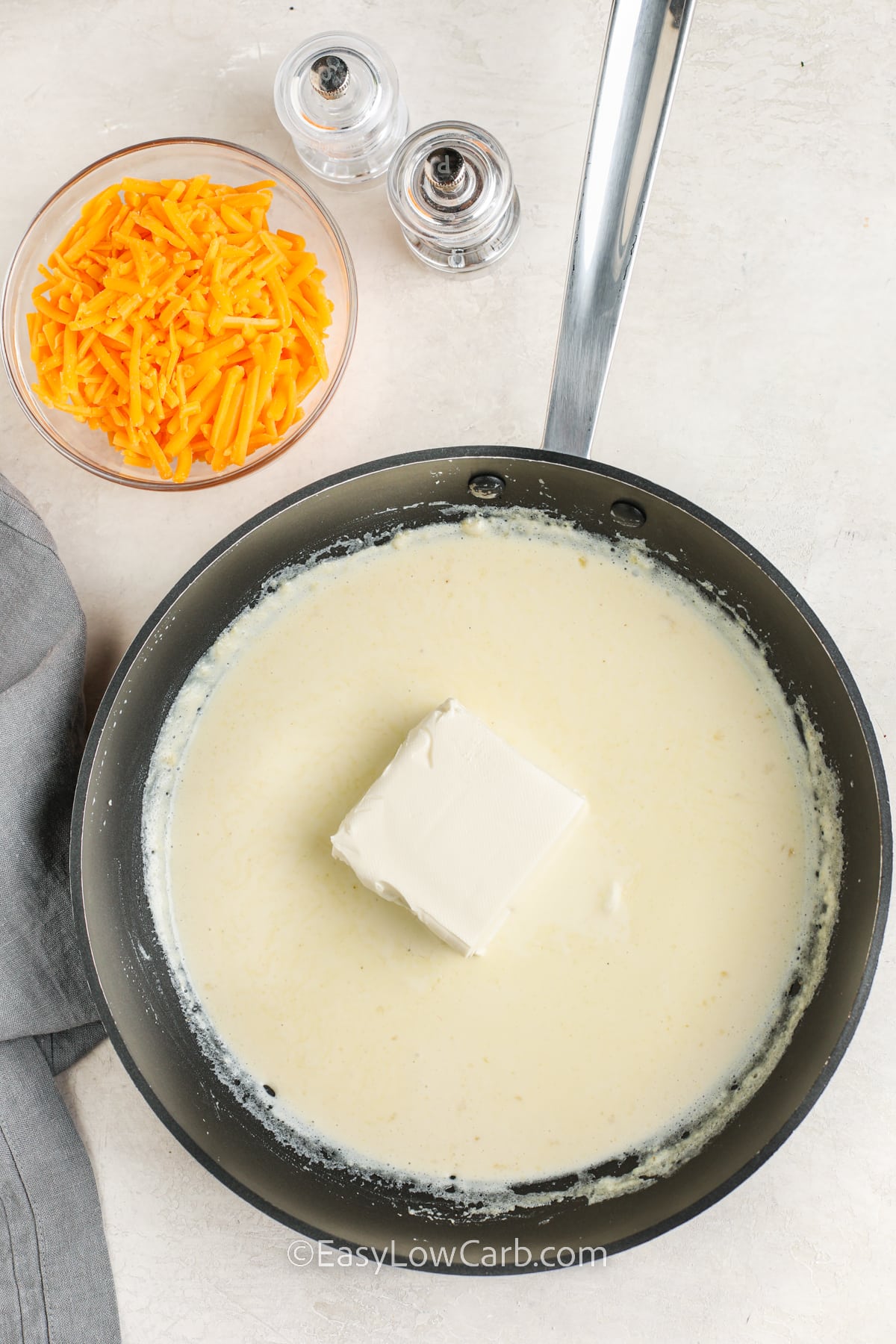 creamy cheese sauce being prepared in a skillet