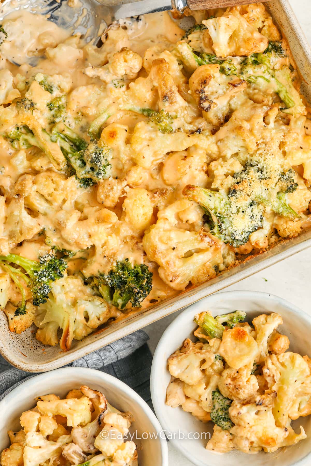 Broccoli cauliflower casserole with two servings in bowls next to it.