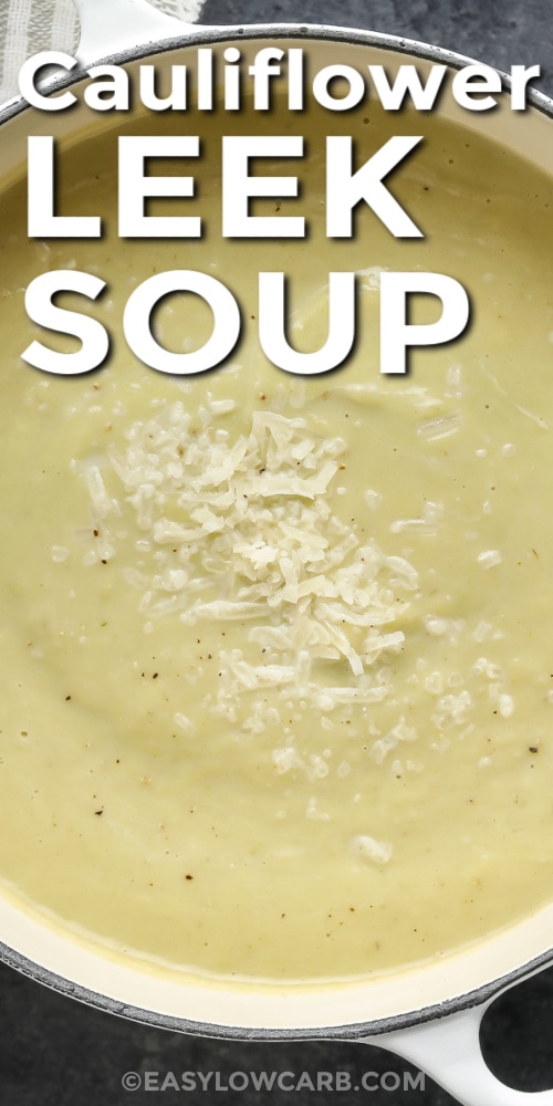 A pot of cauliflower leek soup topped with parmesan cheese with text