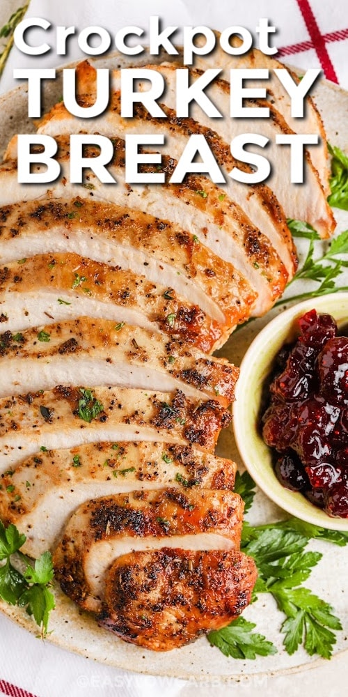 A crockpot turkey breast sliced on a serving platter with text