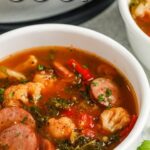 a bowl of sausage kale soup with text