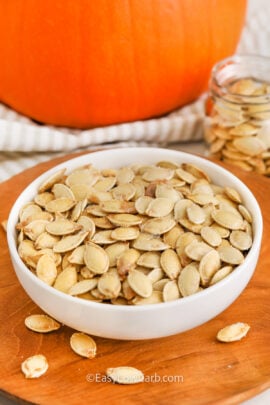 baked pumpkin seeds in a white bowl