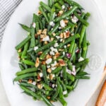 A serving dish with green bean salad