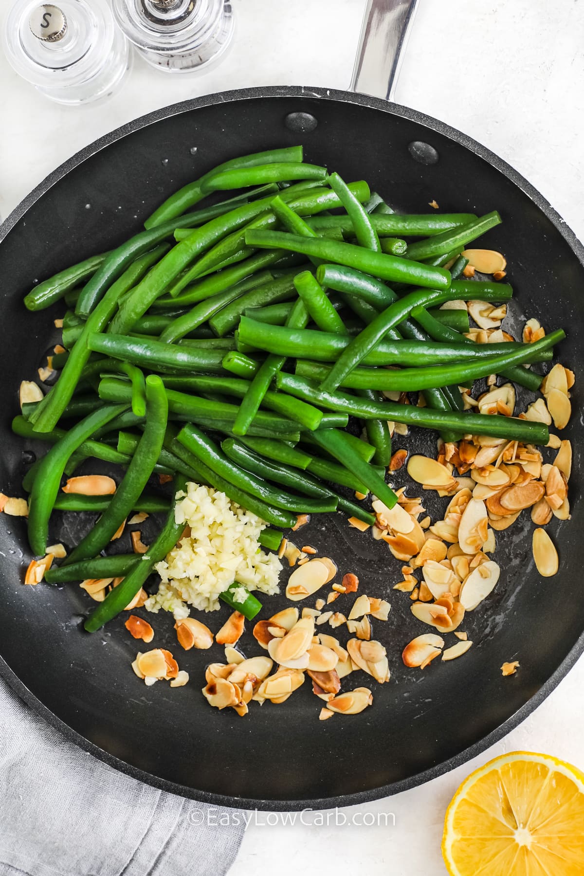 Ingredients to make Green Beans Almondine in a pan