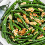 A serving bowl of Green Beans Almondine