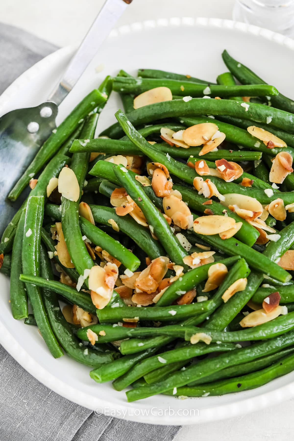 A serving bowl of Green Beans Almondine