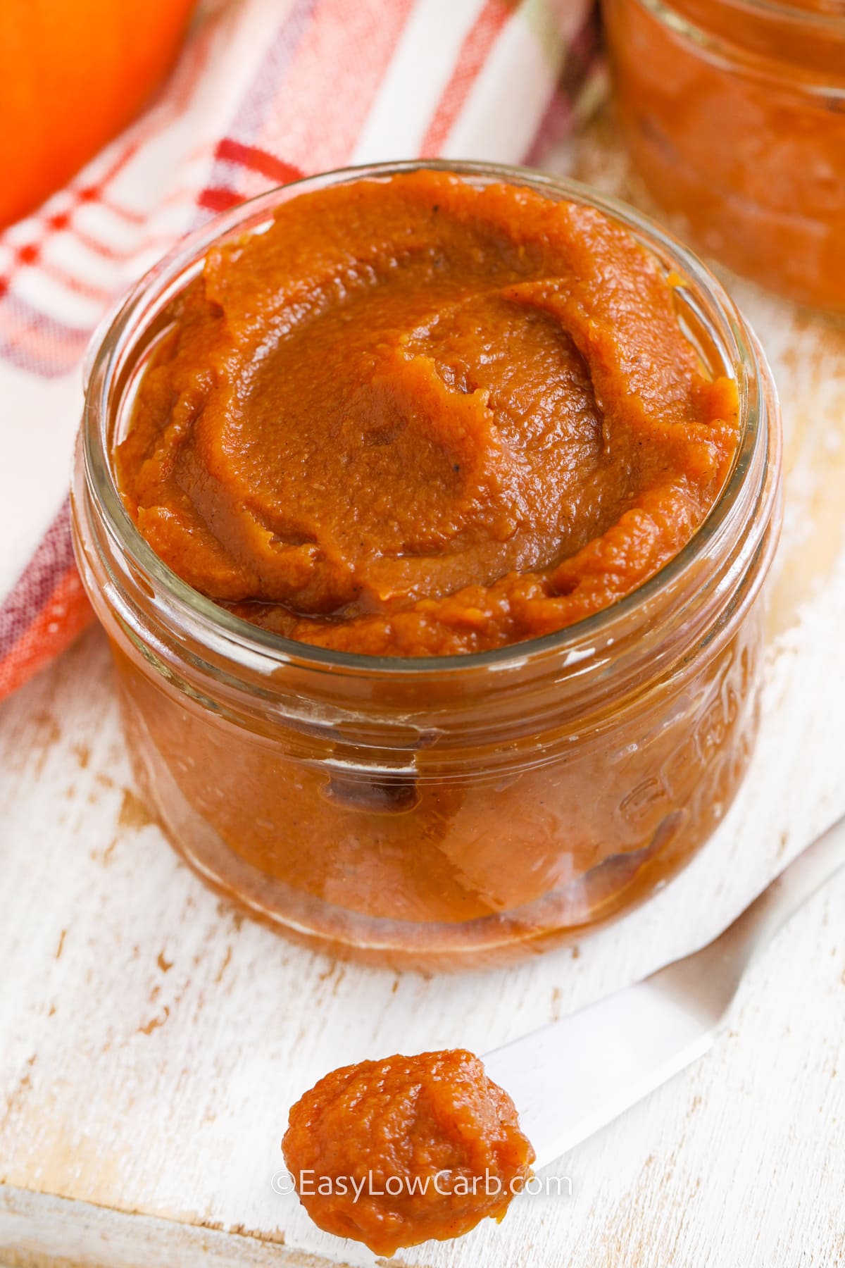 jar of pumpkin butter with some on a knife