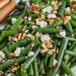 Green beans salad prepared in a serving dish with text
