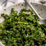 Sauteed kale with garlic and lemon in a serving bowl
