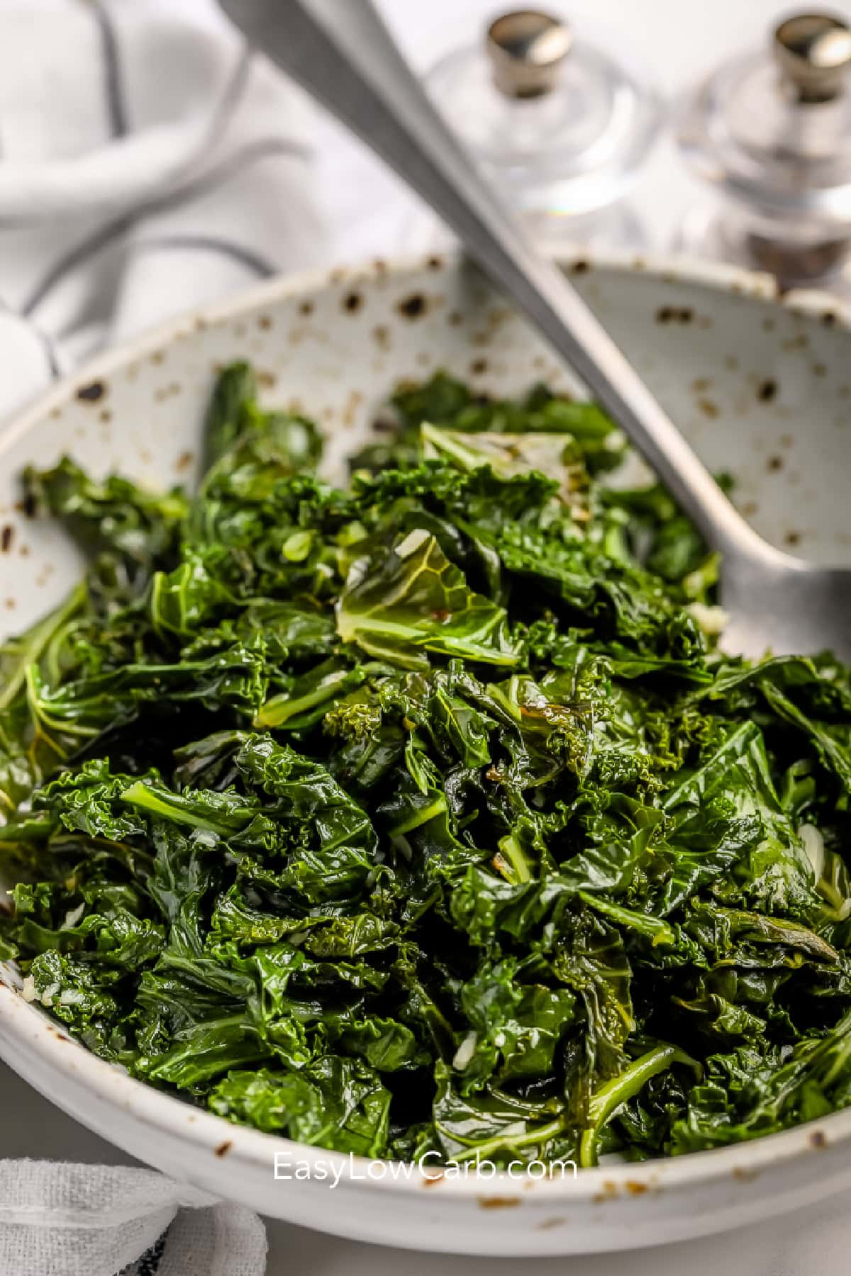 Sauteed kale with garlic and lemon in a serving bowl