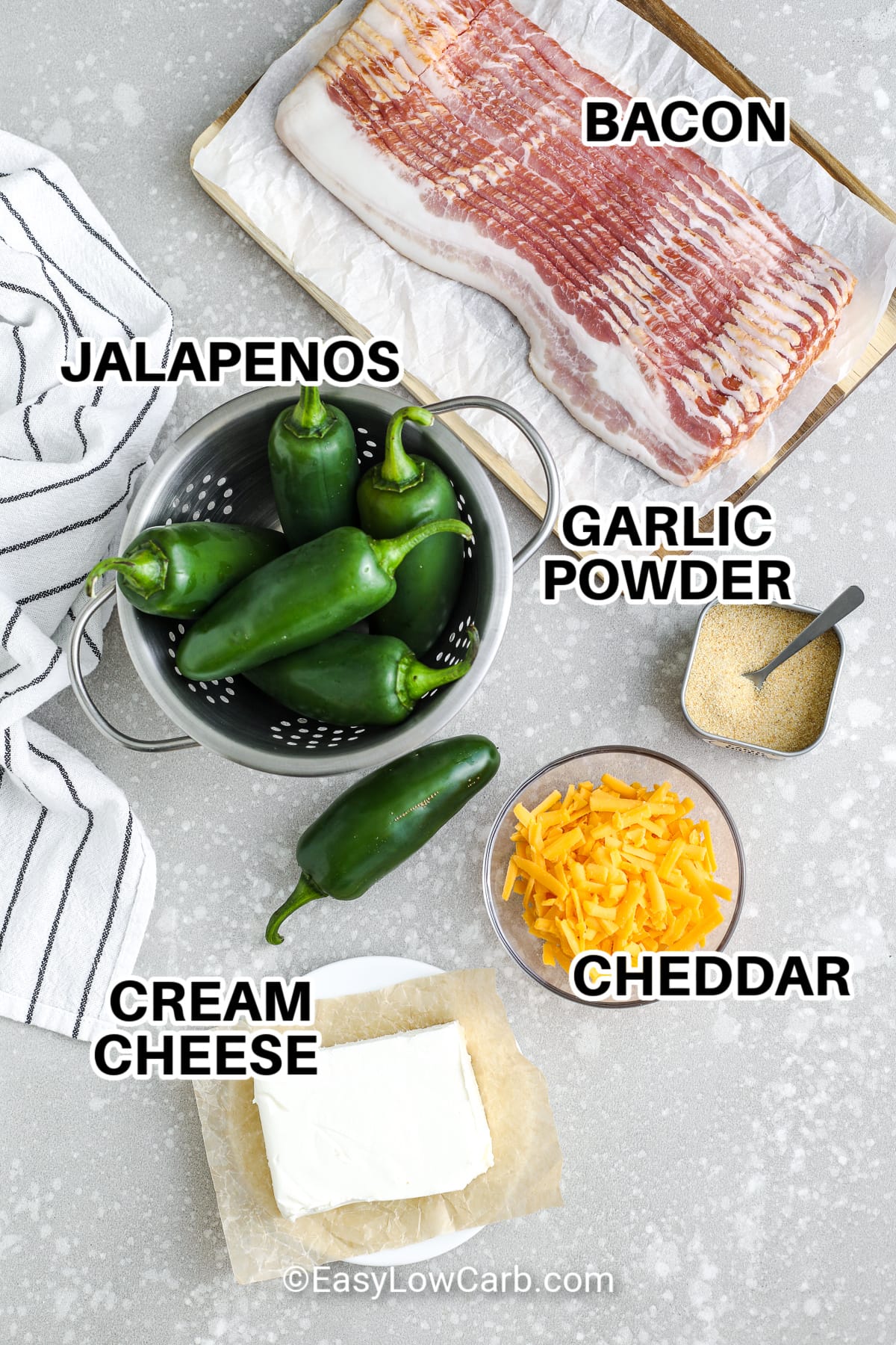ingredients to make bacon wrapped jalapenos including bacon, jalapenos, garlic powder, cheddar, and cream cheese