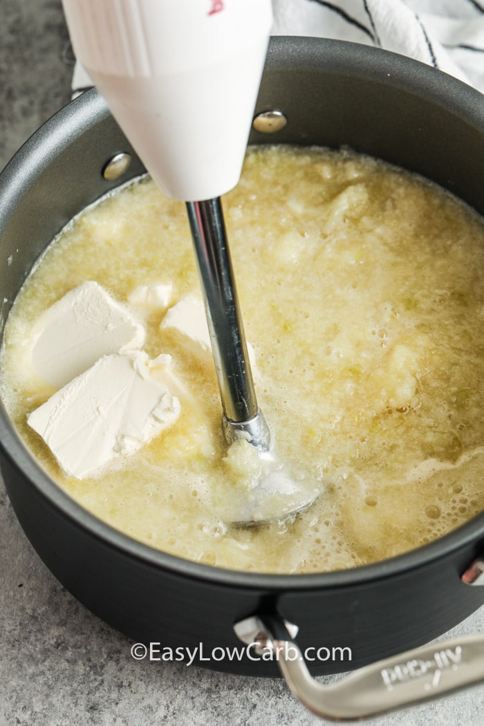 creamy cauliflower soup being blended in a pot