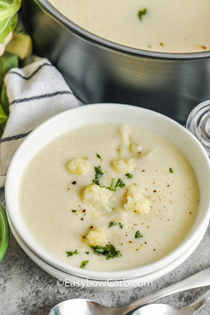 creamy cauliflower soup in a white bowl