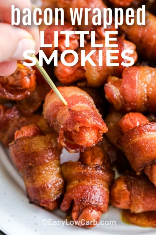 bacon wrapped little smokies with one being picked up with a toothpick and writing
