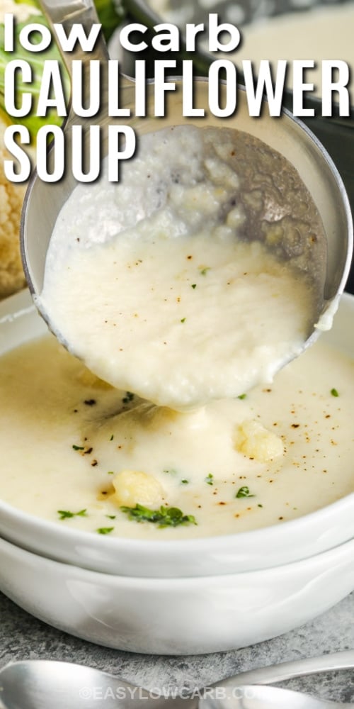 creamy cauliflower soup in a bowl with a ladle and writing