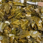 sauteed collard greens in a pan with a spoon and writing
