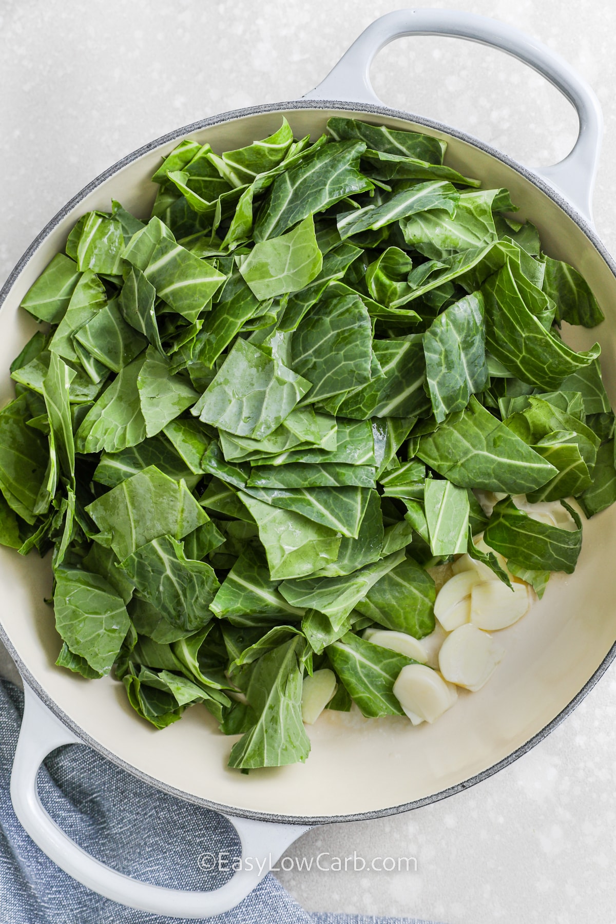 collard greens with slices of garlic in a pan