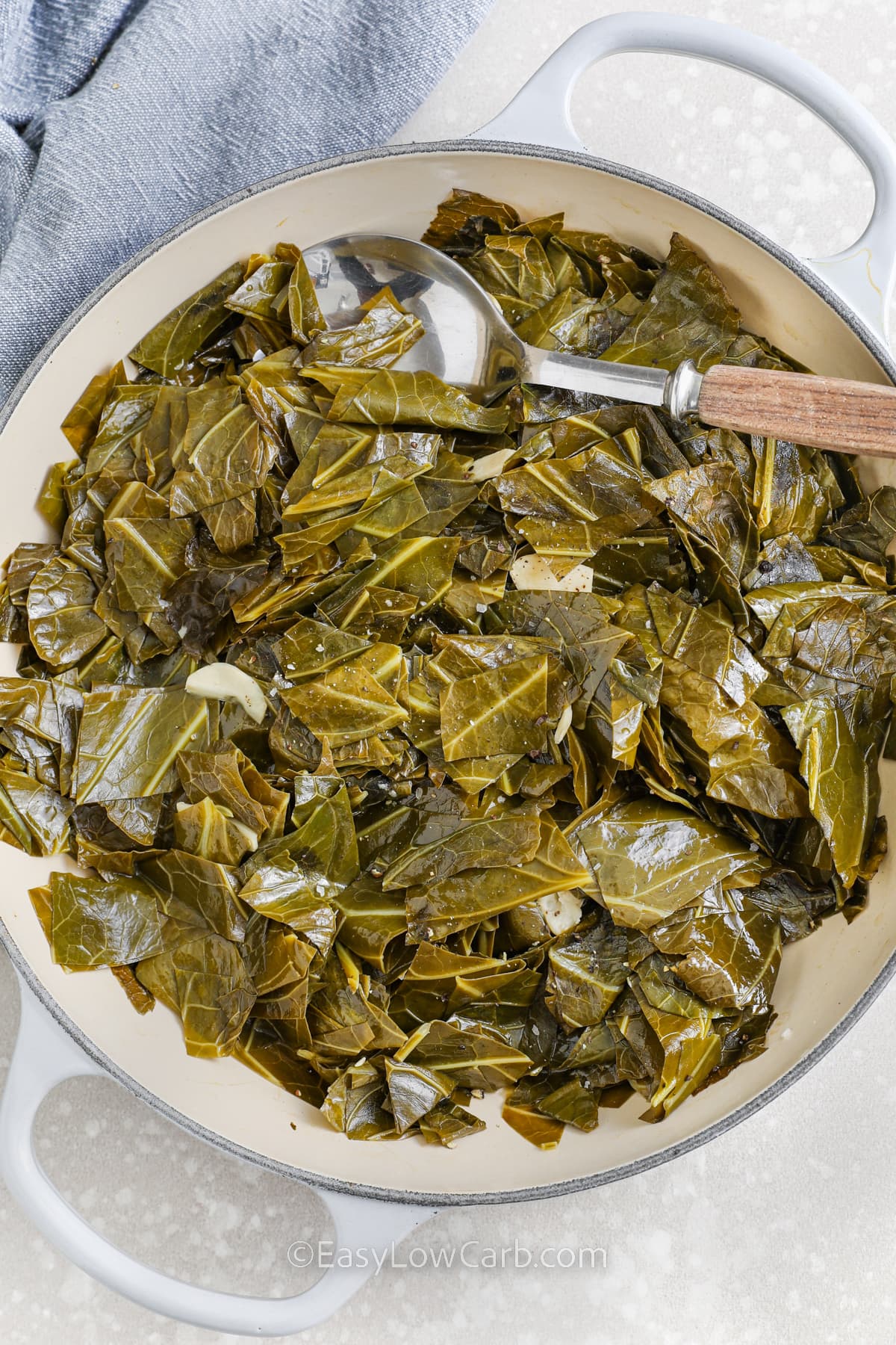 sauteed collard greens in a pan with a spoon