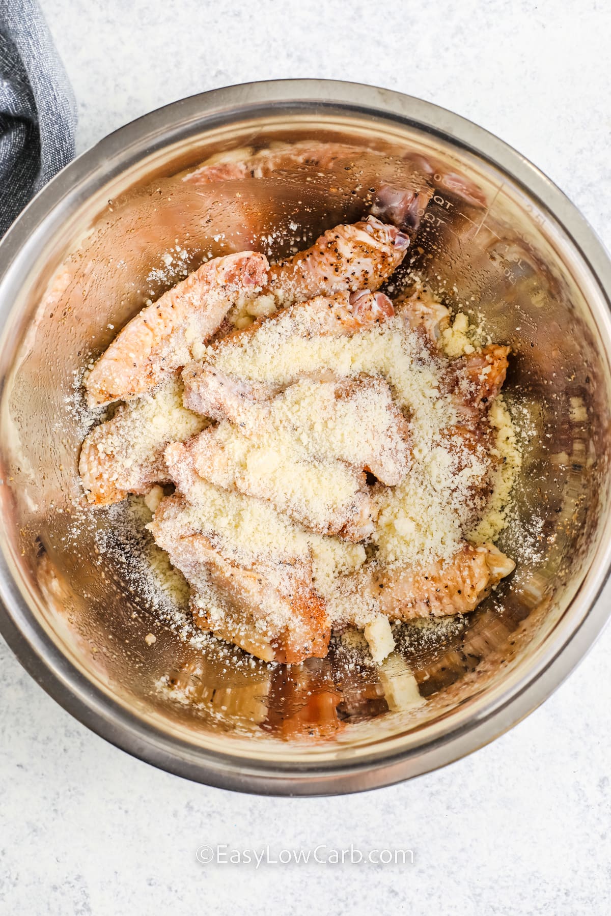 adding parmesan to chicken to make Keto Chicken Wings