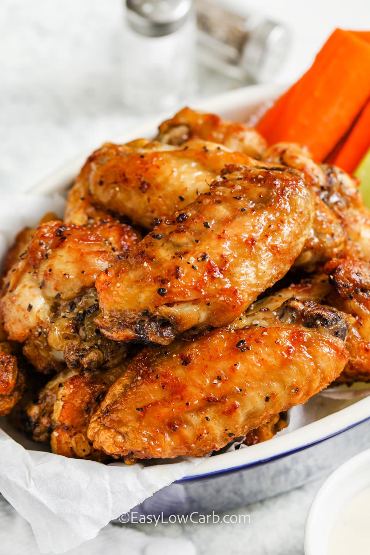 plated Salt and Pepper Chicken Wings with carrots and celery