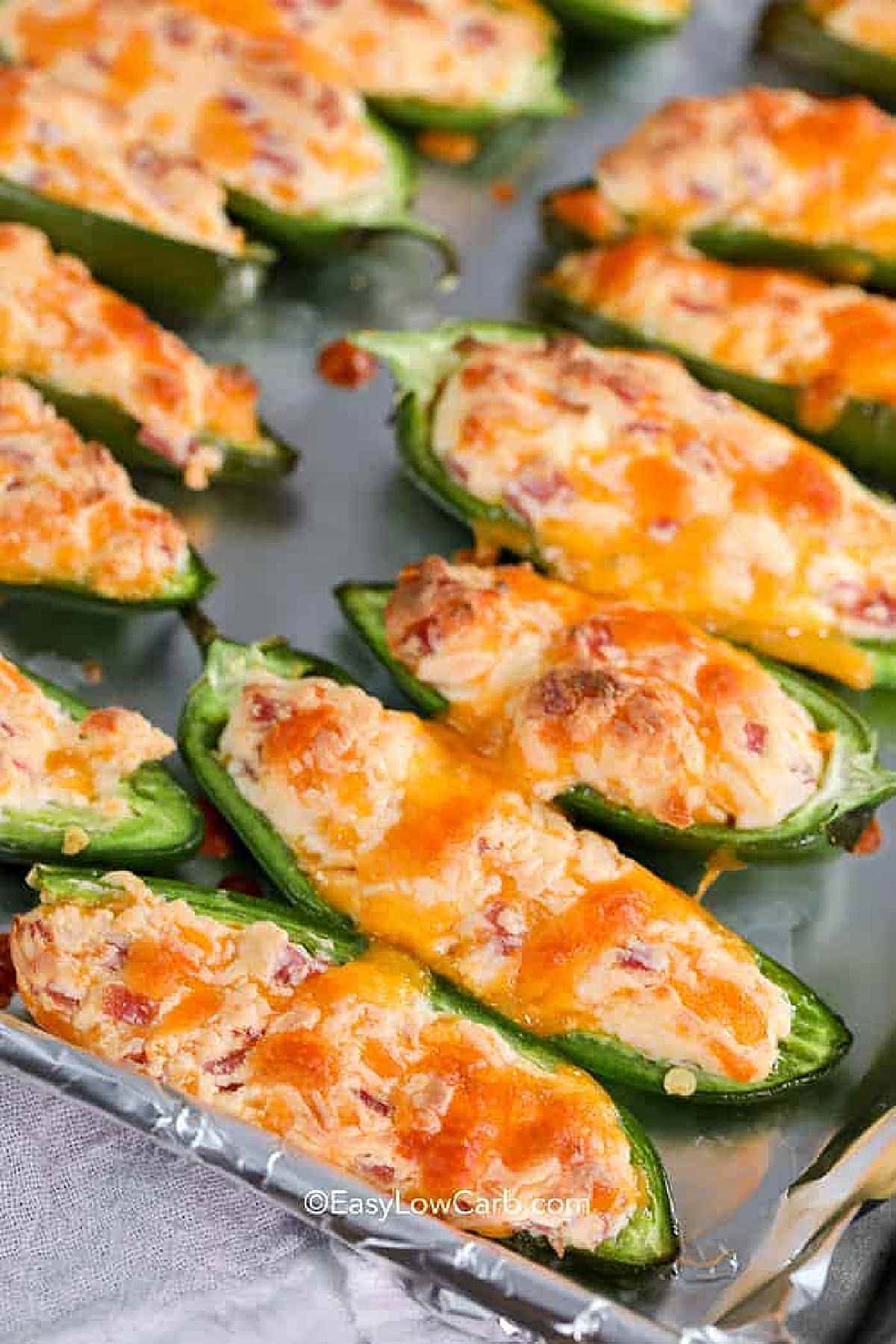 a baking sheet full of Baked Jalapeno Poppers