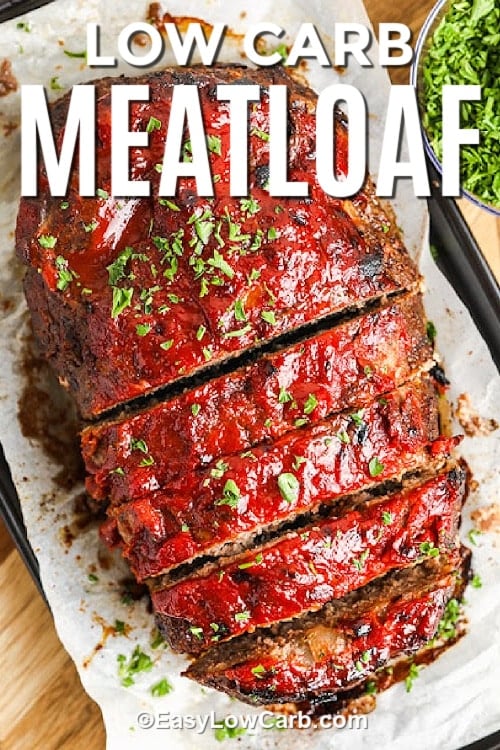 Sliced low carb meatloaf on a parchment lined baking sheet, with a title