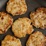 cooked Turkey Breakfast Sausage Patties in a pan with a title