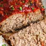 cooked low carb meatloaf, on a parchment lined baking sheet, with writing