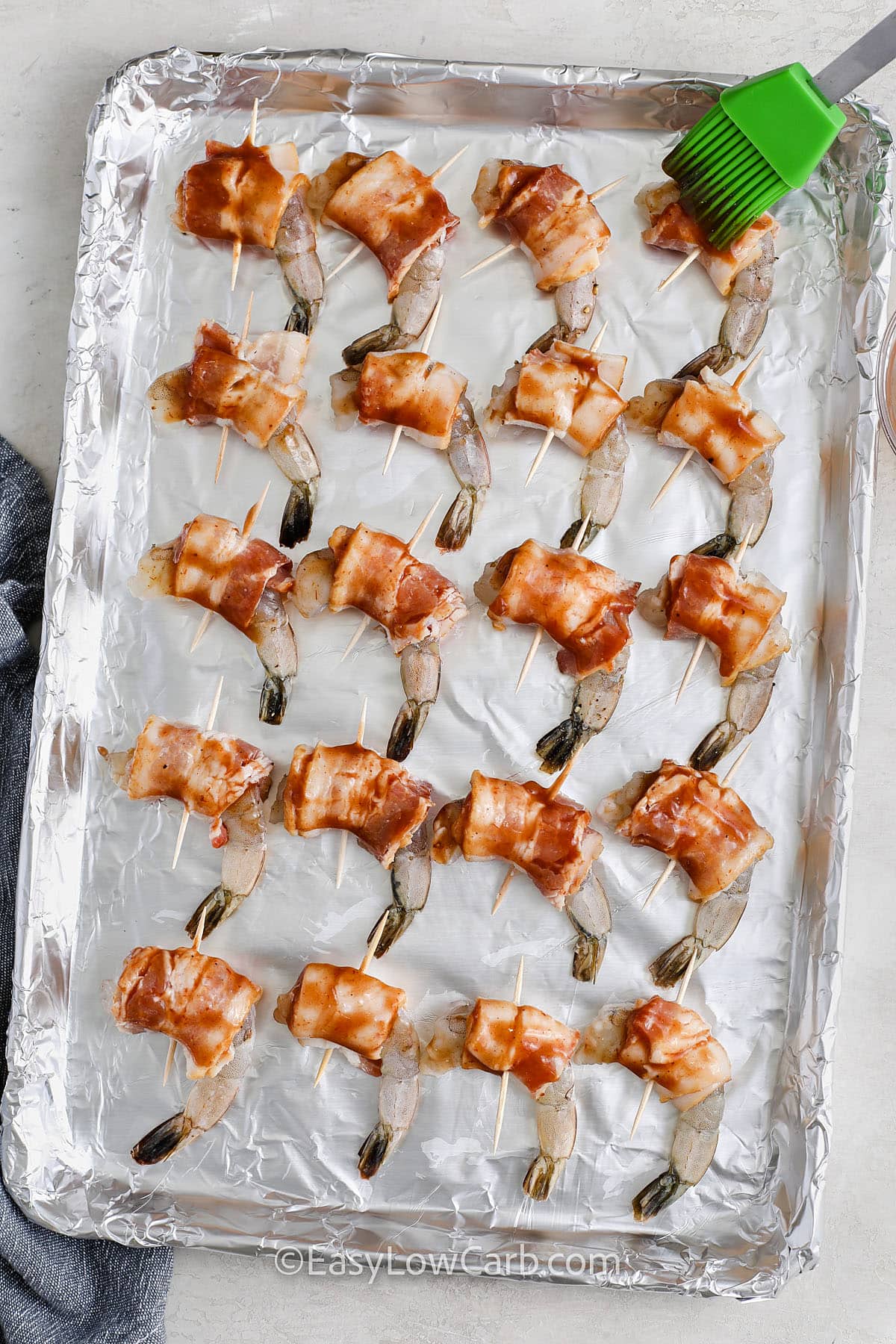 Bacon Wrapped Shrimp prepared on a baking sheet