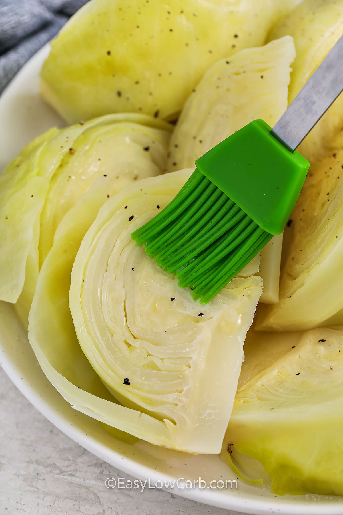 brushing butter over Boiled Cabbage
