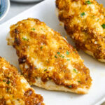 Three baked chicken breasts on a plate