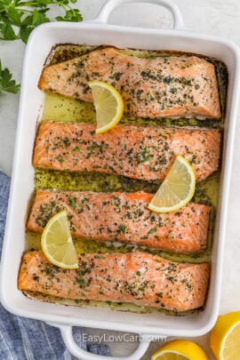 cooked garlic butter salmon filets topped with lemon slices