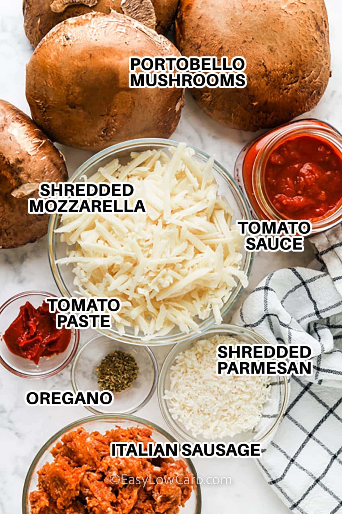 Ingredients to make Portobello Mushroom Pizza labeled: portobello mushrooms, shredded mozzarella, tomato sauce, shredded parmesan, tomato paste, oregano, and Italian Sausage