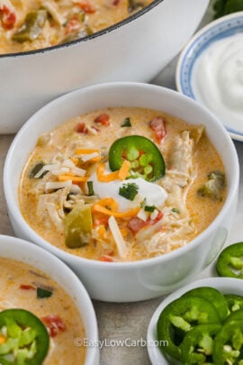 A bowl of chicken taco soup topped with sliced jalapenos