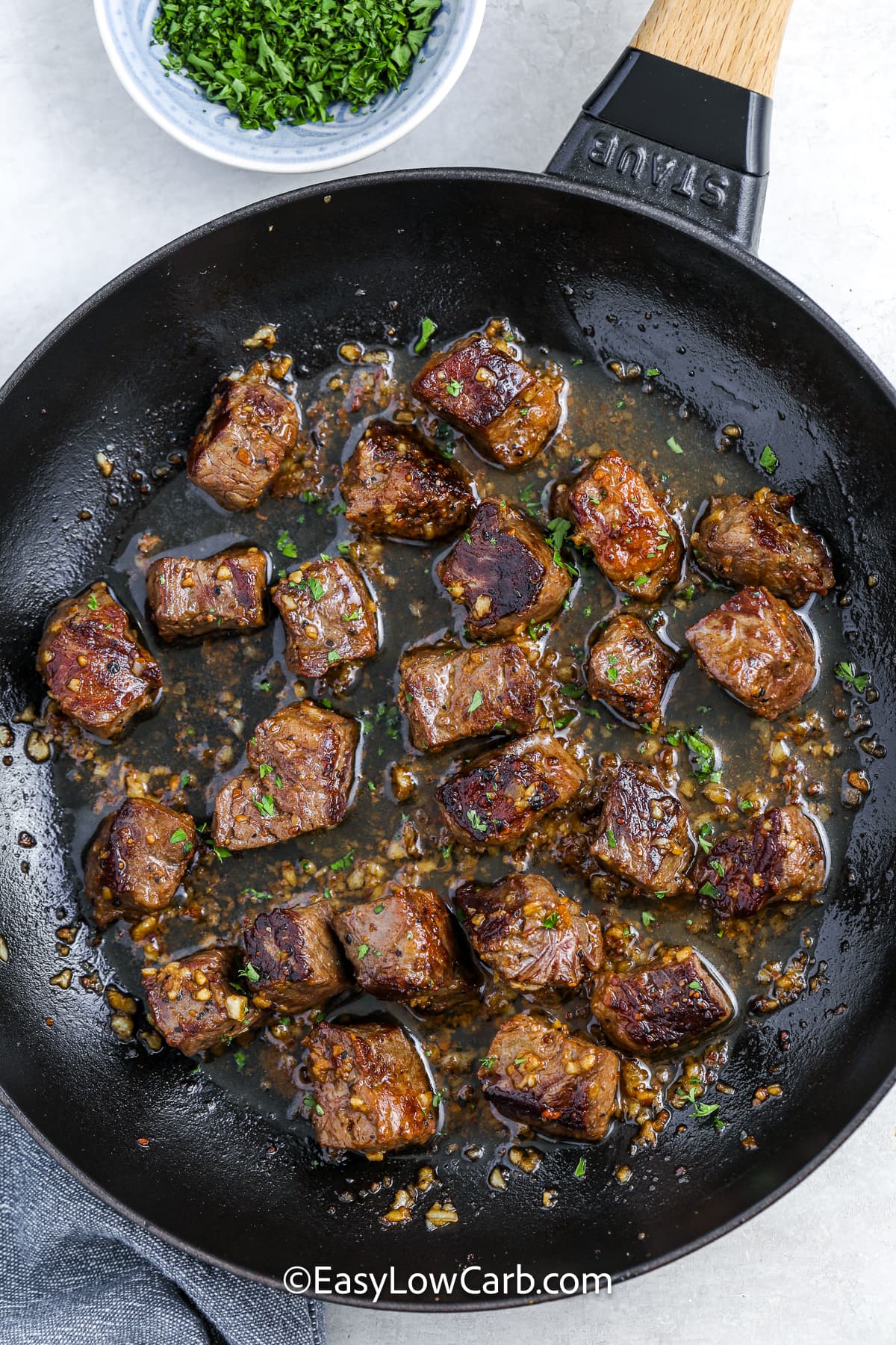 garlic steak bites sizzling in a pan