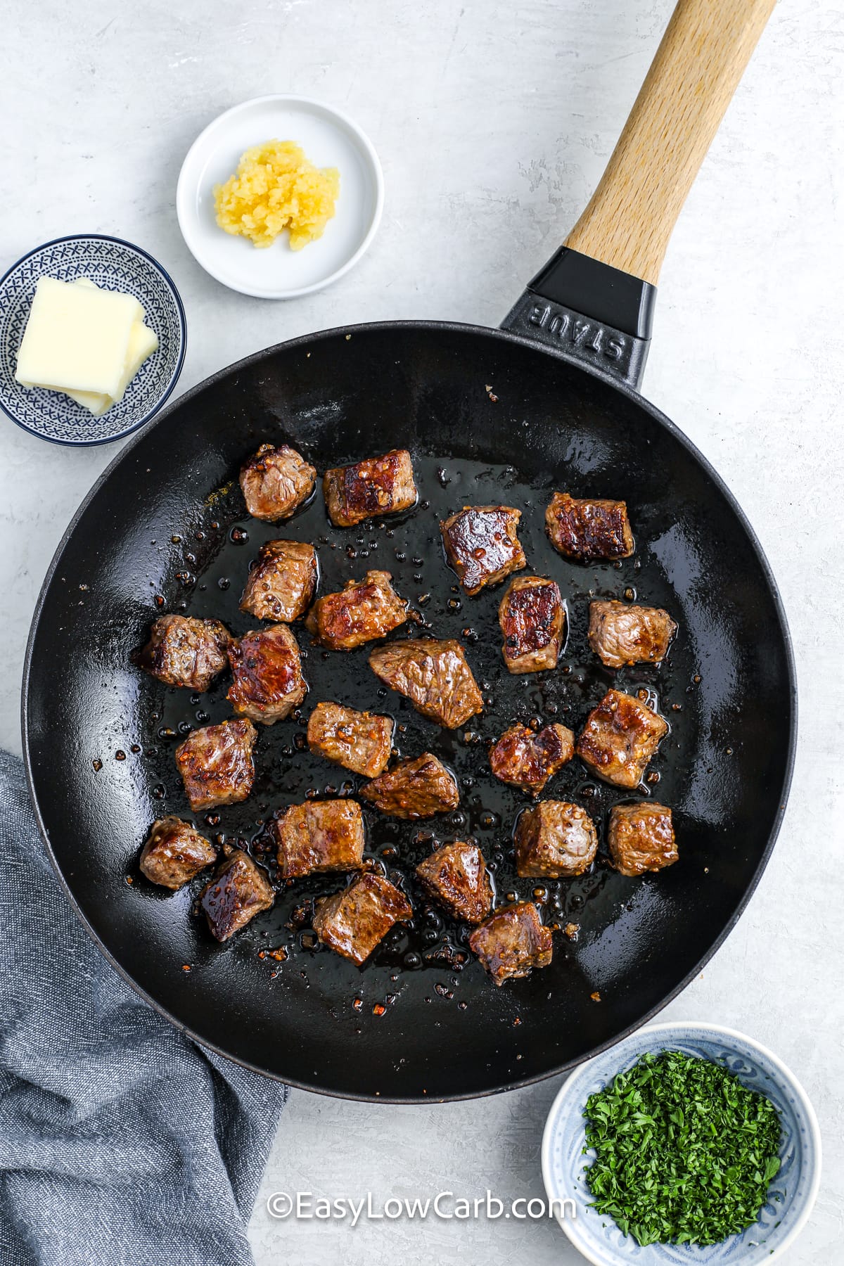 garlic steak bites cooking in a pan