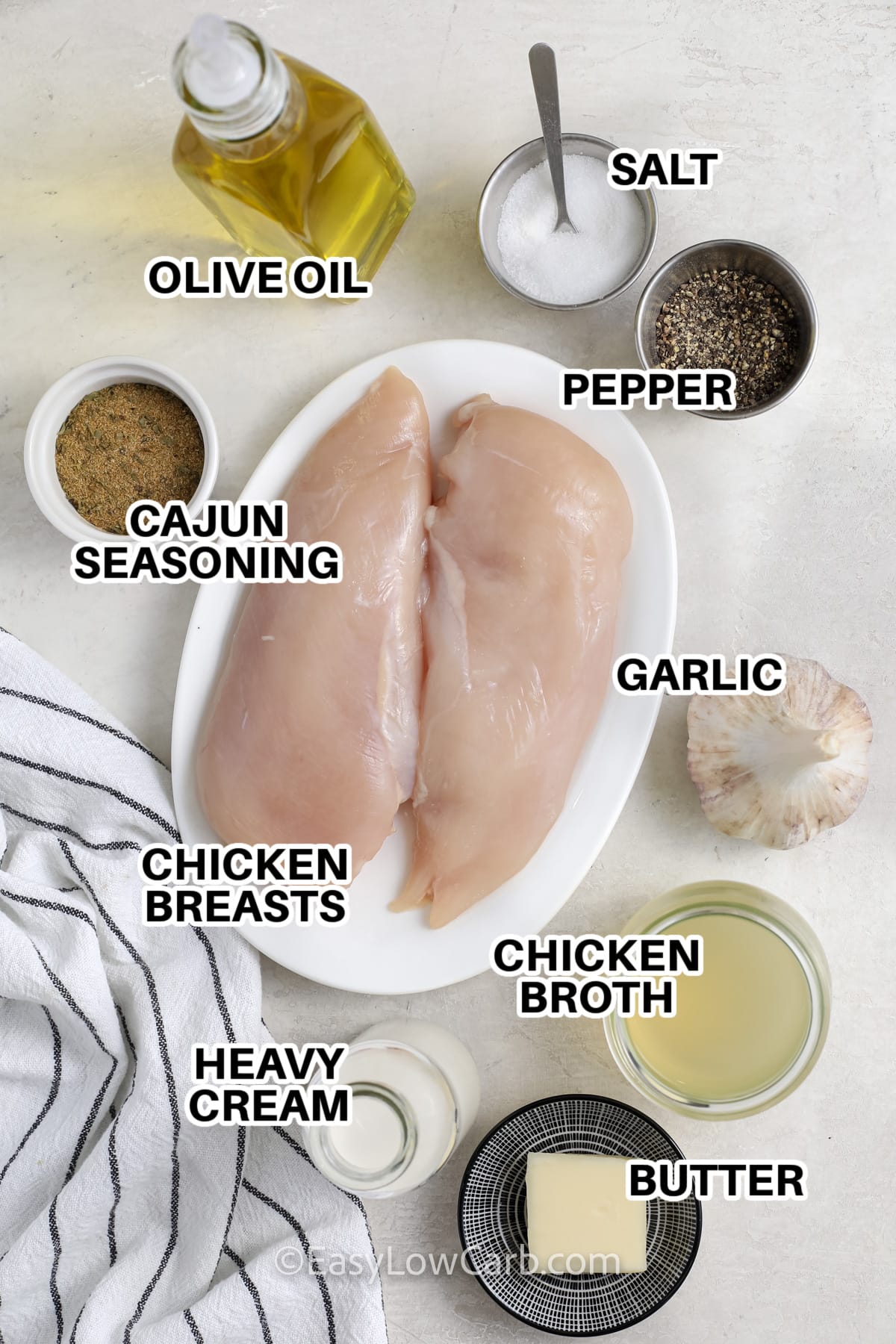 ingredients to make cajun chicken labeled: olive oil, salt, pepper, cajun seasoning, garlic, chicken breasts, chicken broth, heavy cream, and butter