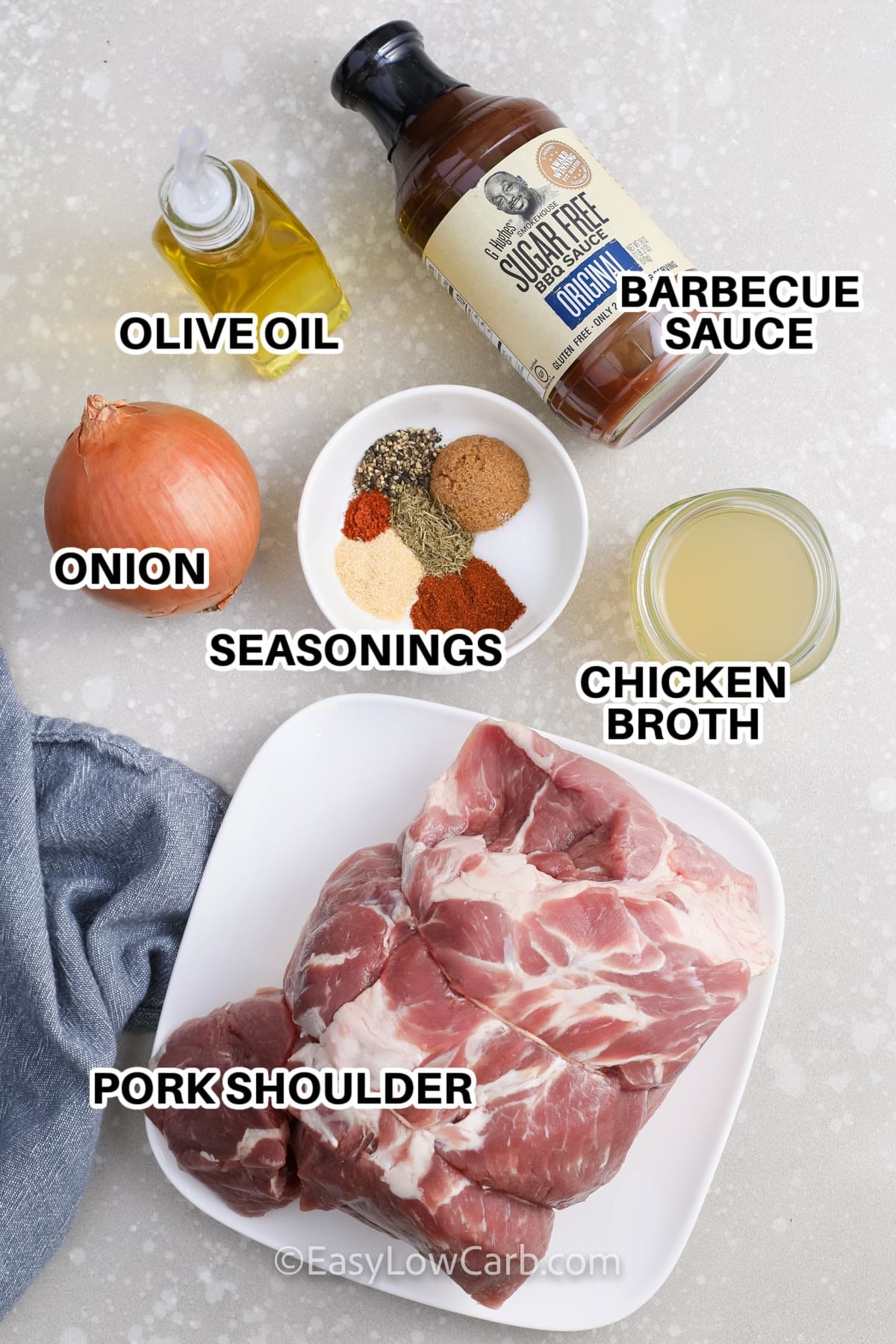 ingredients to make crockpot pulled pork: barbecue sauce, olive oil, onion, seasonings, chicken broth, pork shoulder