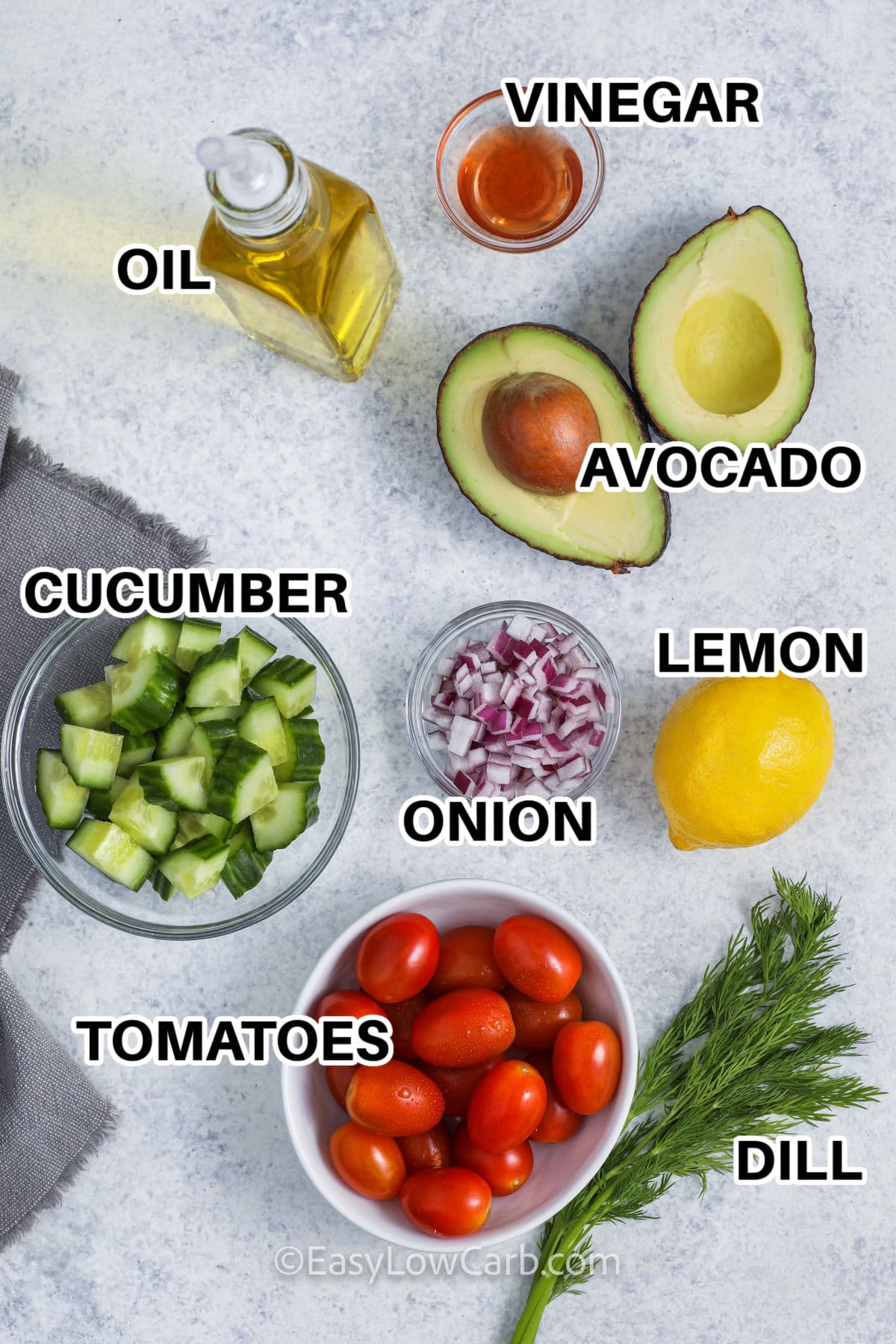oil vinegar avocado cucumber onion lemon tomatoes and dill with labels to make Cucumber Tomato Avocado Salad