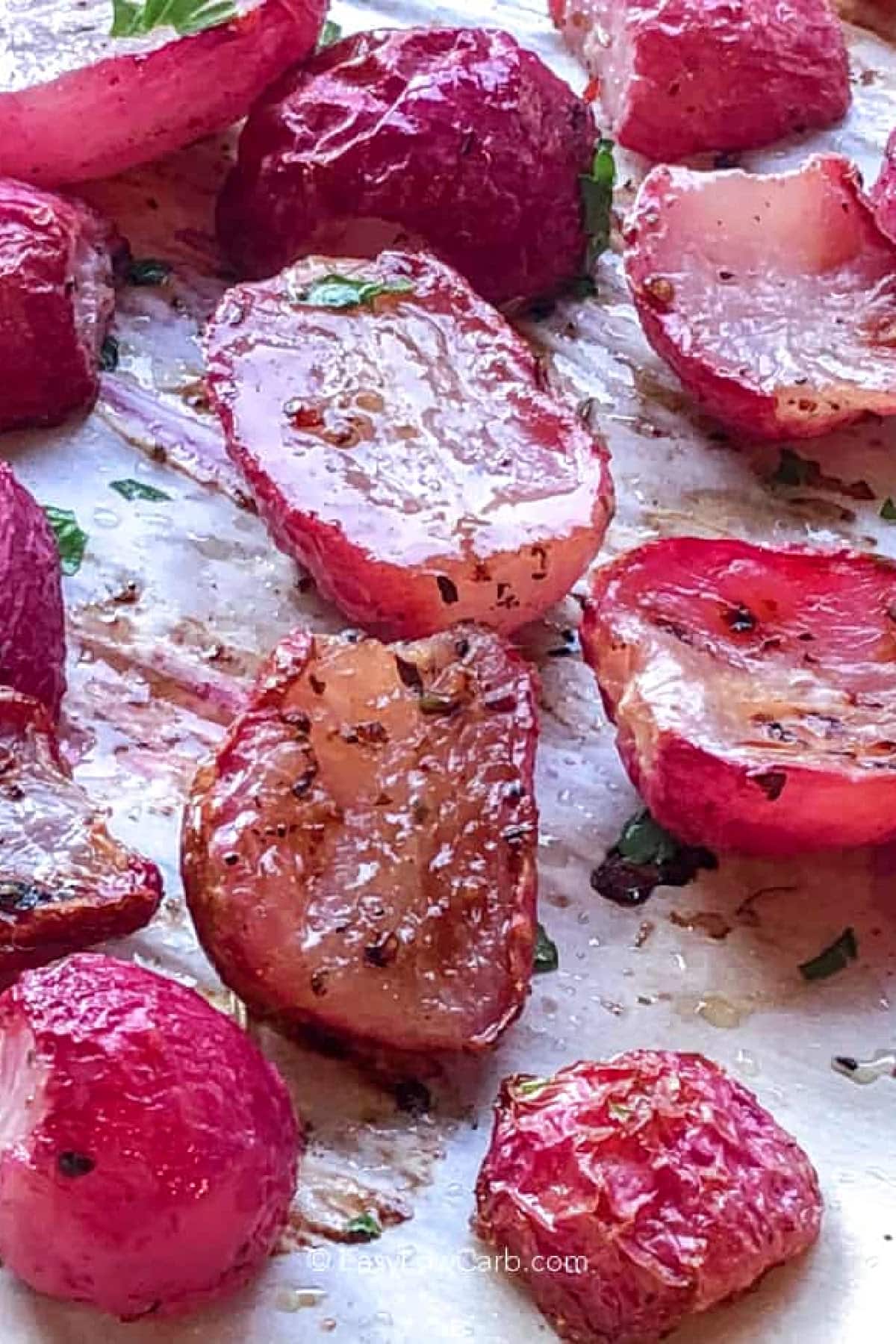 roasted radishes recipe on a parchment lined sheet