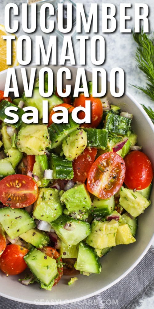 fresh Cucumber Tomato Avocado Salad in a bowl with writing