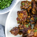 garlic steak bites on a plate with text