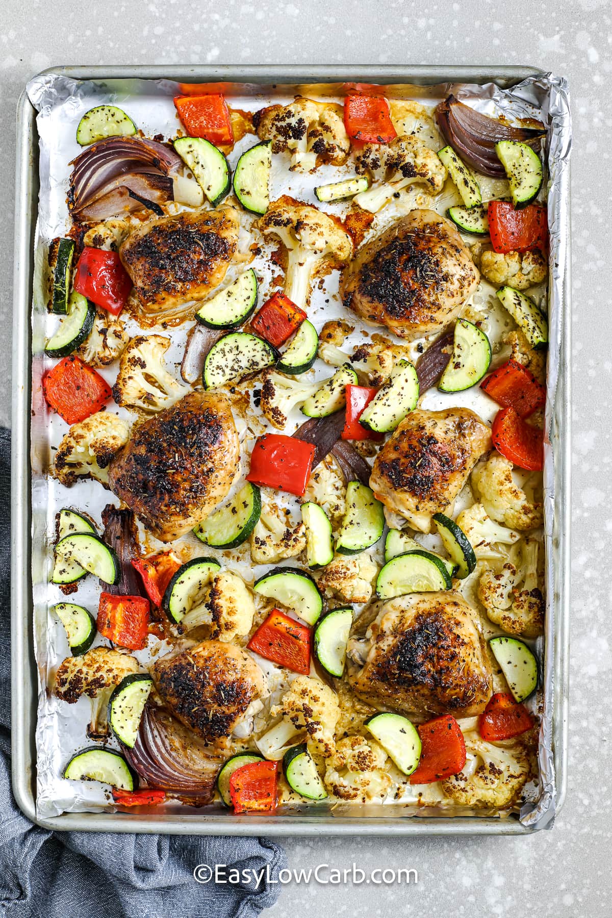 cooked sheet pan chicken and veggies on a pan