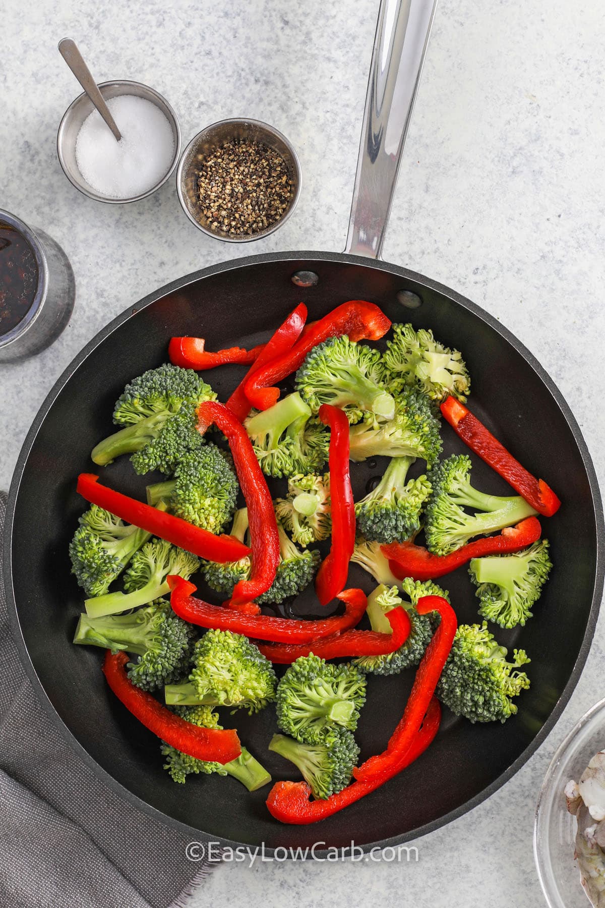 cooking broccoli and peppers in a pan to make Shrimp and Broccoli Recipe
