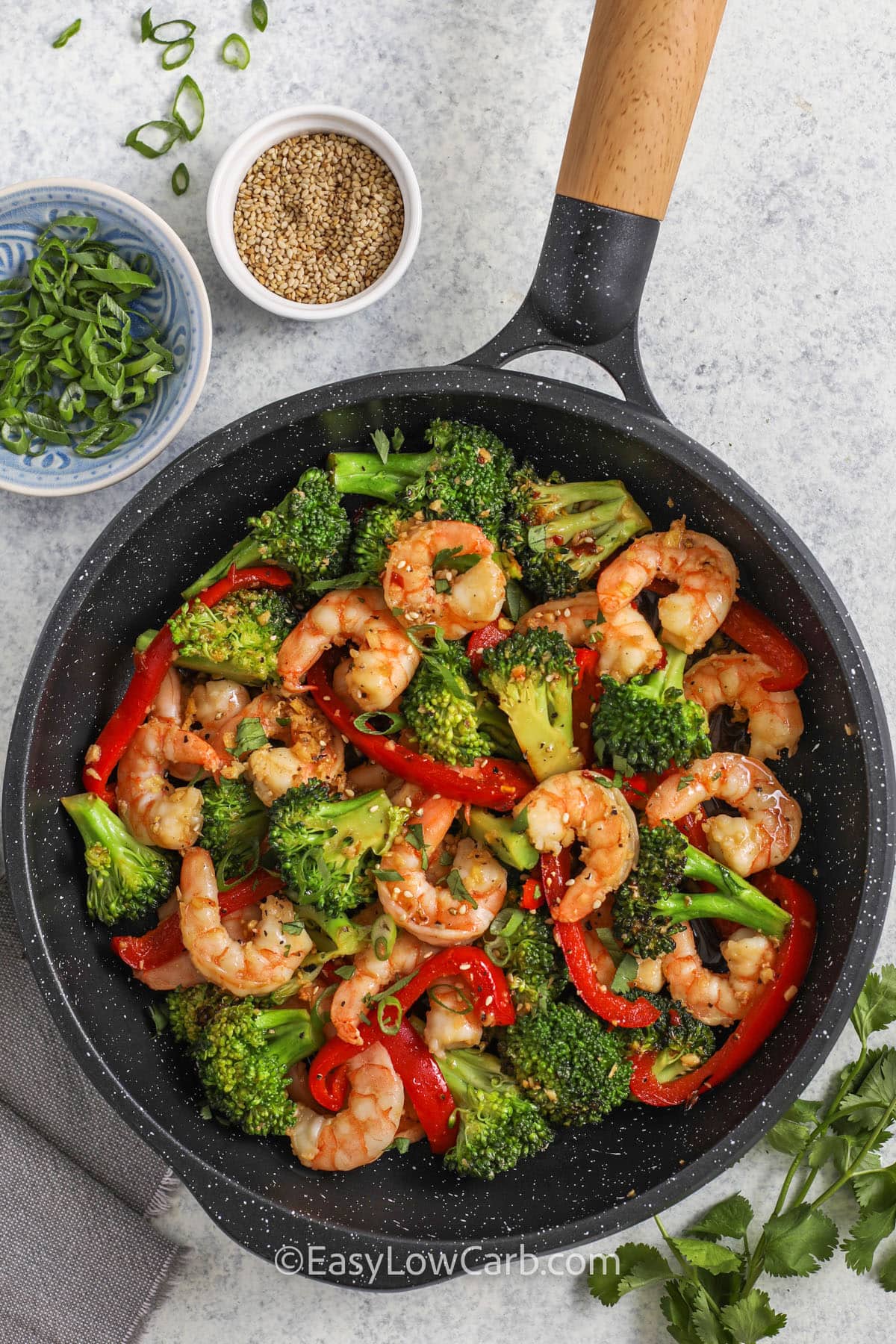 adding broccoli and pepper to shrimp in pan to make Shrimp and Broccoli Recipe