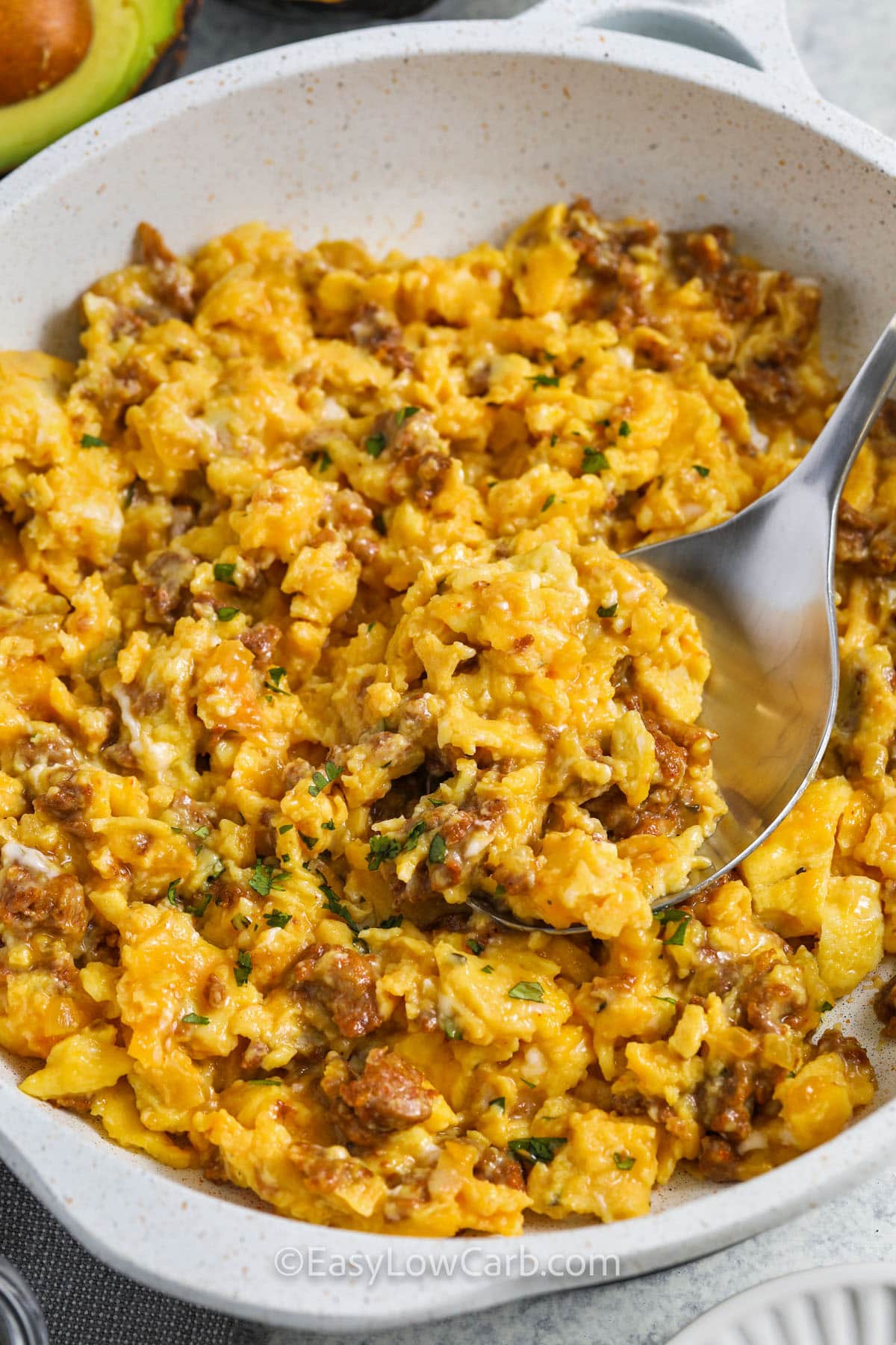 taking a spoonful of Chorizo and Eggs Recipe out of the pan