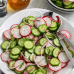 Cucumber Radish Salad in a bowl with spoons