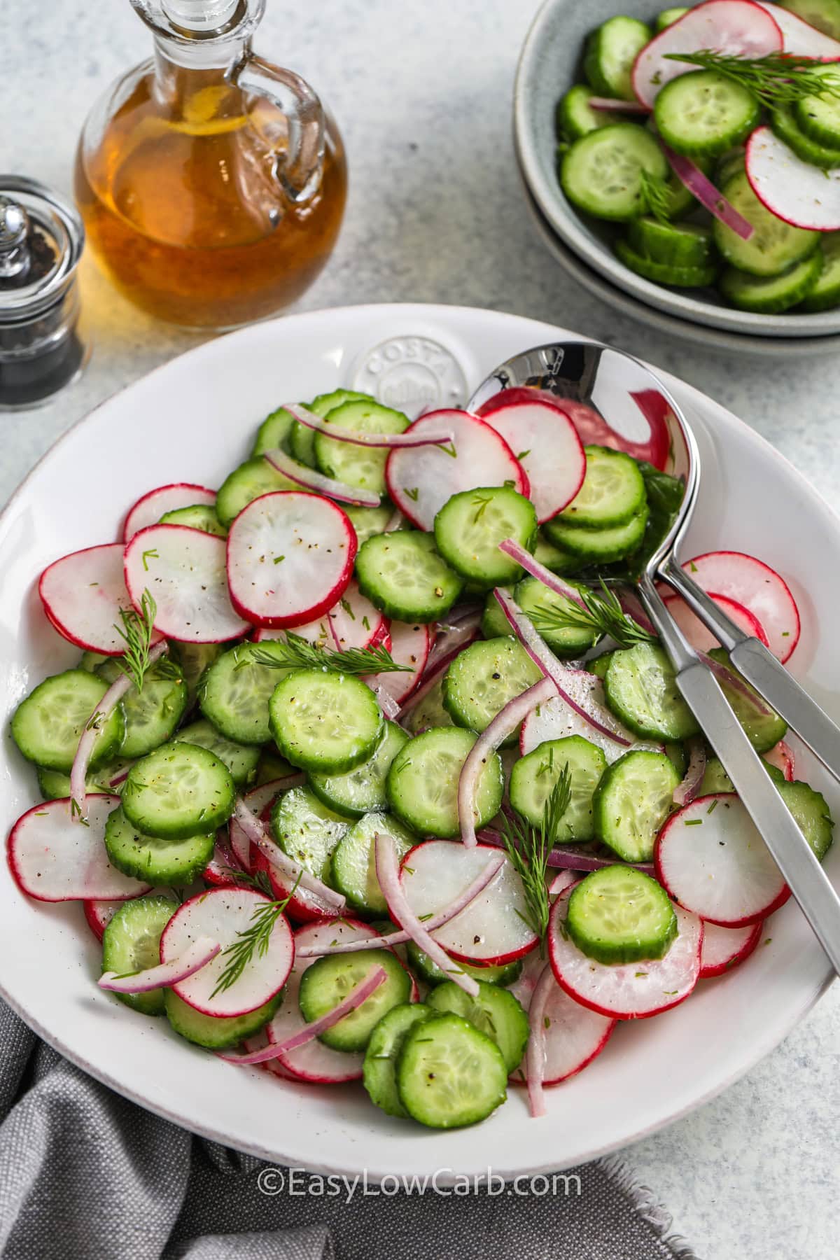 Cucumber Radish Salad in a bowl with spoons